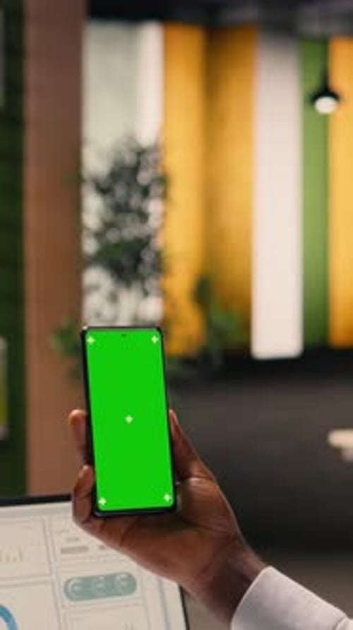 Vertical Video Vertical Chroma Key Phone Held By African American Man Working Alone in Office
