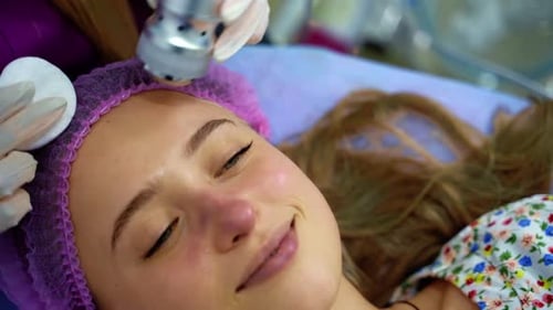 Woman Receiving Forehead Skin Treatment in Clinic