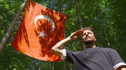 Man in Woods Salutes Red Flag