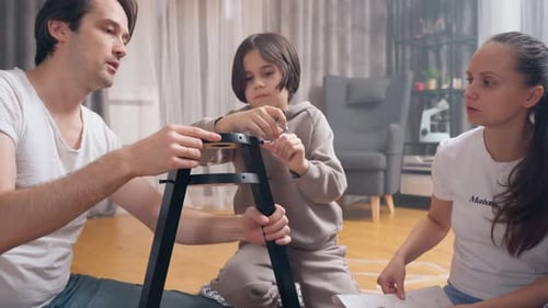Family Assembling Furniture Together at Home