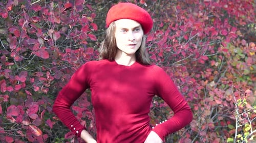 Young Beautiful Sensual Woman in a Red Sweater and Beret Posing in the Autumn Forest Against a