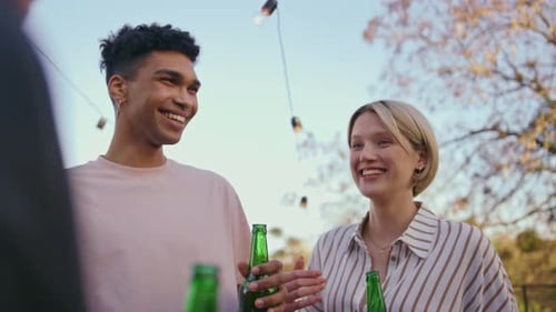 Friends Enjoying Drinks and Conversation Outside on Sunny Day