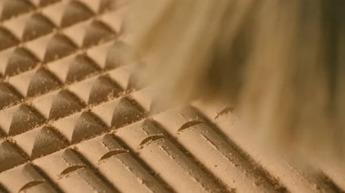 Close-up of machine cutting patterns on wood