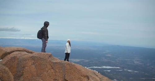 Couple Climbing Up Mountain, Hiking Rocky Mountains in Snow Adventure