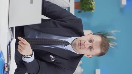 Vertical video of Home office worker man getting bad news from camera.