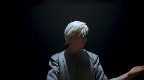 Man in glasses interacts with a virtual interface