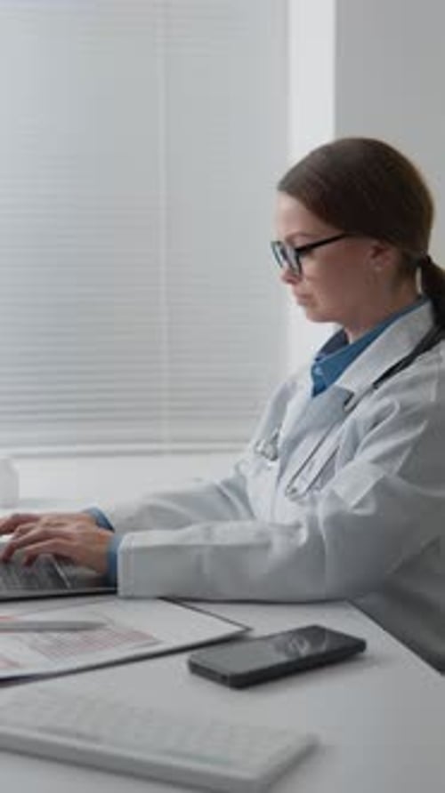 Female Doctor Working on Laptop in Clinic
