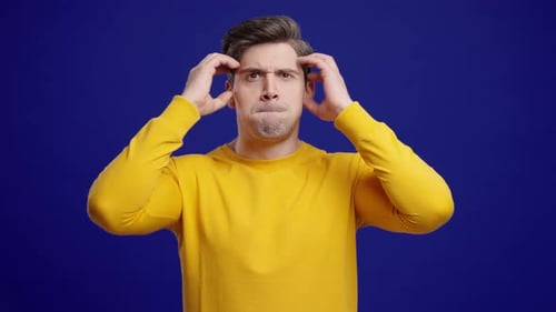 Shocked Man Reacts with Surprise on Blue Background