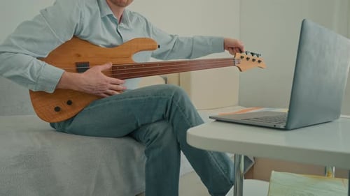Man Playing Bass Guitar at Home