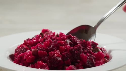 Russian Beetroot Vinaigrette Salad with Green Peas Boiled Vegetables and Dill Close Up in Restaurant