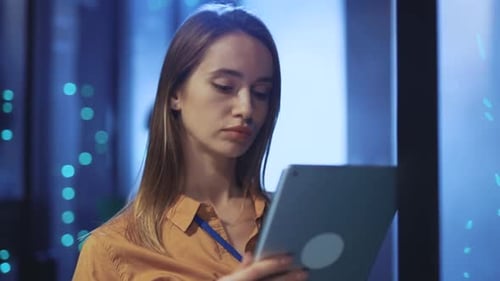 Woman Uses Tablet in Data Center Server Room
