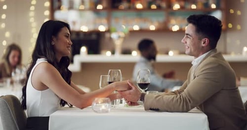 4k video footage of a happy young couple having a romantic date at a fancy restaurant
