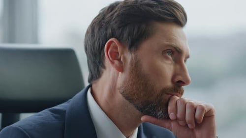 Bearded Businessman Thinking About Business Ideas Sitting at Modern Office Close Up