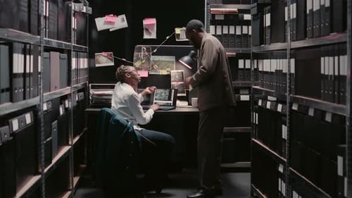 Detectives Collaborate in Cramped Office Investigation