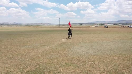 Horseback Rider with Flag in a Rural Field