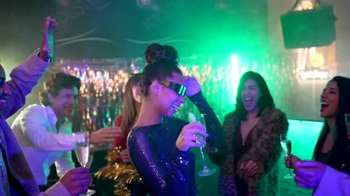 Group Dancing, Celebrating with Champagne in Nightclub