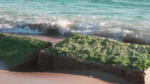 Wave from the ocean splashing against a rock in slow motion.
