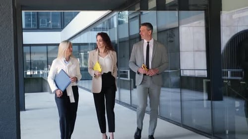Businesspeople walking outside office building