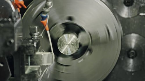 Precision metal lathe shaping workpiece in industrial setting