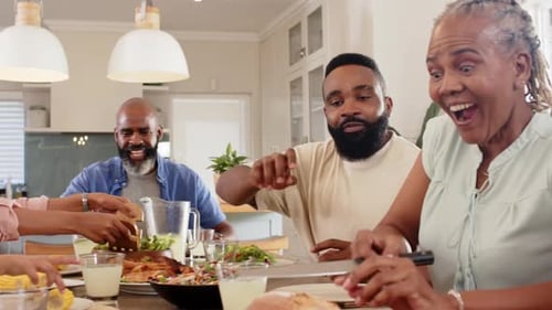 Family Laughing Together at a Meal