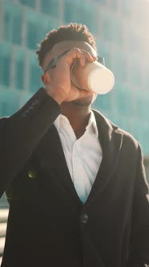 Black Man Drinking Coffee Outdoors in City Street in Morning Vertical Video Businessman Starting