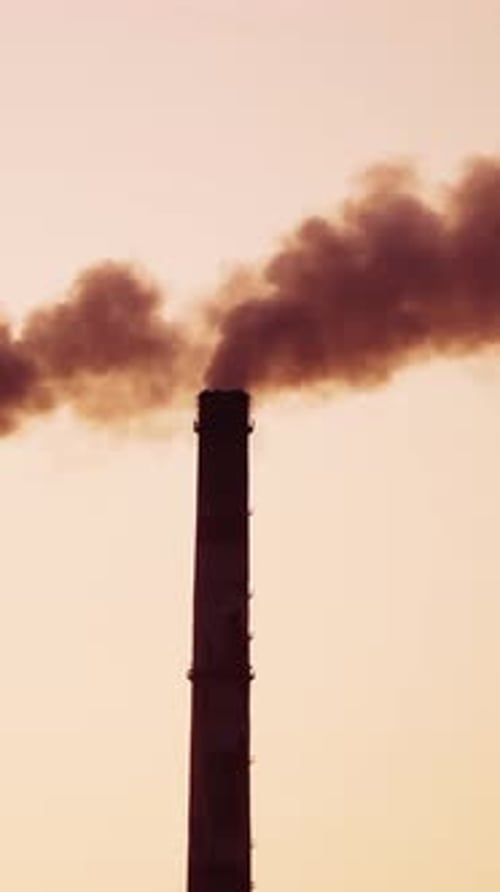 Chimney from polluting factory. Smoke of pipes pollutes atmosphere of the planet Vertical video