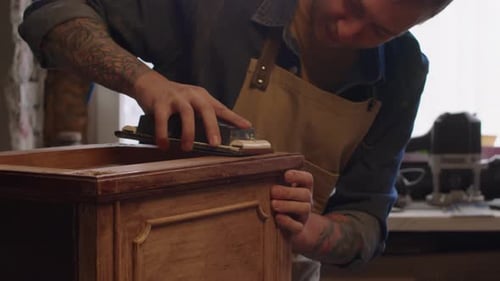 Carpenter Renovating Old Furniture in Workshop