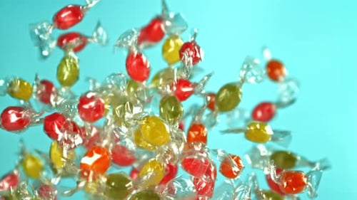 Colorful Candies Falling in Slow Motion on Blue