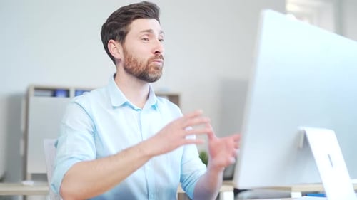 Man Speaking on Video Call in Bright Office