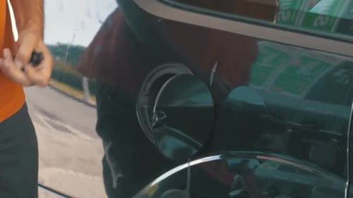 Man Filling Car with Gas Man's Hand Using a Petrol Pump to Fill His Car Up with Fuel