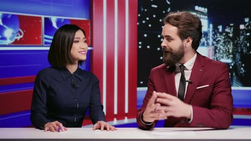 News Anchors Talking in a Modern Broadcast Studio