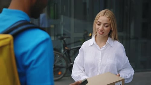 Delivery Person Handing Package to Woman