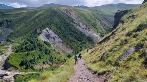 Group of Hikers Walking on a Trail in the Mountains