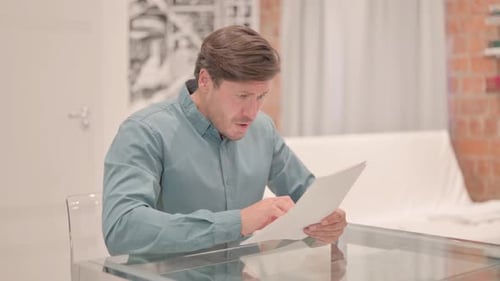 Upset Mature Adult Man Reacting to Business Report, Loss