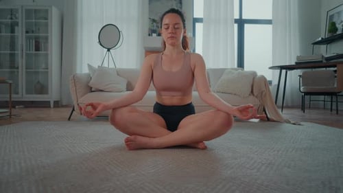 Woman Practicing Yoga in Living Room
