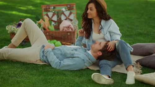 Smiling Couple Relaxing Together on Picnic Blanket