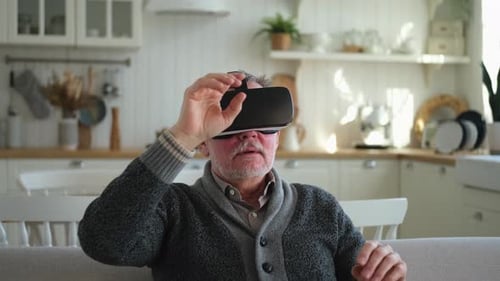 Senior Man Experiencing Virtual Reality Headset at Home