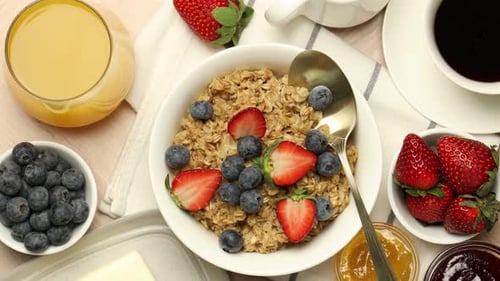 Oatmeal breakfast with berries and fruit, overhead view