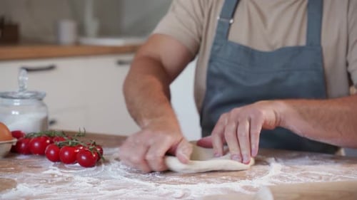 Hands Kneading Dough with Flour in Kitchen