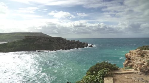 Ghajn Tuffieha Bay with Il-Qarraba Rock and Raging Turquoise Colour Mediterranean Sea