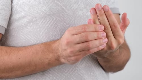 Adult Male Rubbing Hand Fingers for Pain Relief