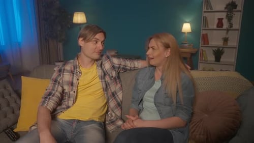A Married Couple is Sitting on the Sofa in the Evening Talking A Man Shares the Events of the Day