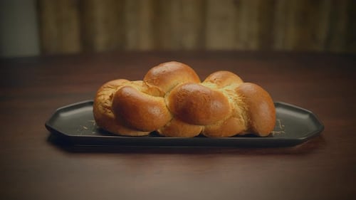 Golden Brown Braided Challah on Dark Plate