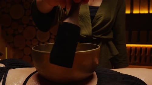 Closeup View Of Traditional Bowl For Sound Massage And Sound Therapy On Female Belly Enjoying Music