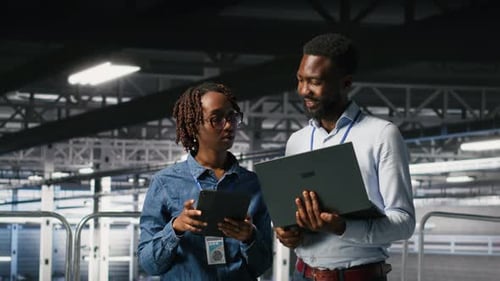 Data Center Coworkers Doing Maintenance Tasks on Laptop