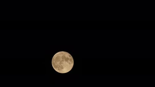 Full Moon Shines in Dark Night Sky