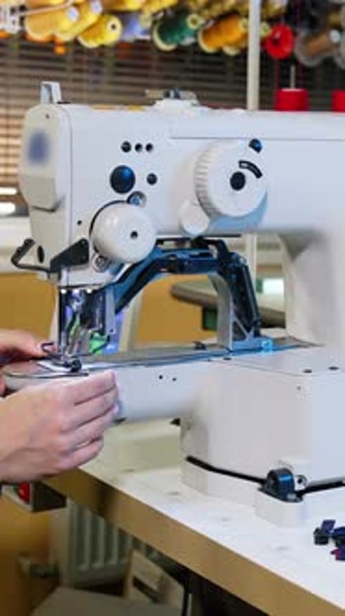 Seamstresses work in main sewing shop. Close up of tailor hands working at the sewing factory