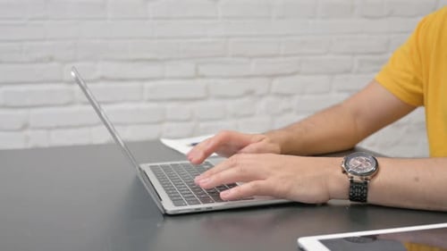 Side View of Man Typing on Laptop