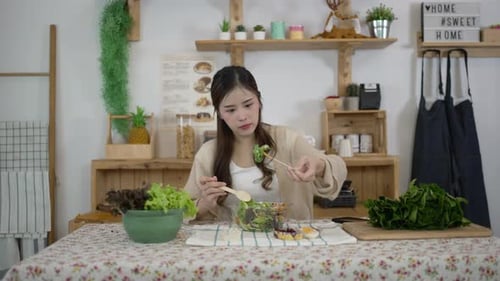 Woman Enjoys Preparing and Eating Healthy Salad at Home