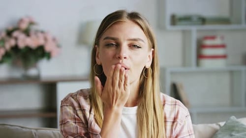Woman Blows a Kiss to the Camera